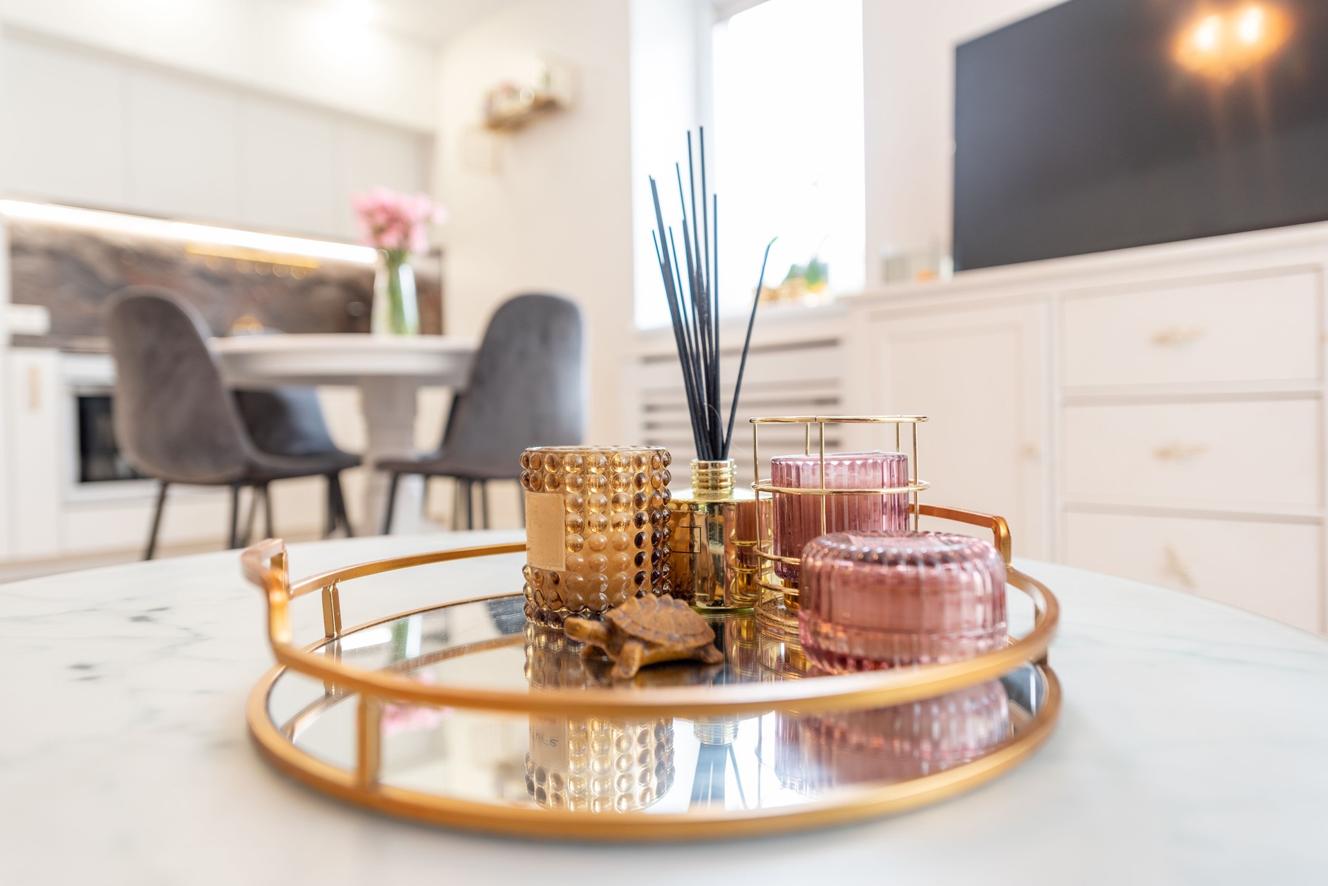 Elegant Golden Tray with Candles and Reed Diffuser in Modern Living Room